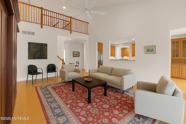 258 Rolling Meadows Blvd N, Ocean Twp, NJ 07712 - living area featuring light wood-type flooring, ceiling fan, high vaulted ceiling, stairway, and baseboards