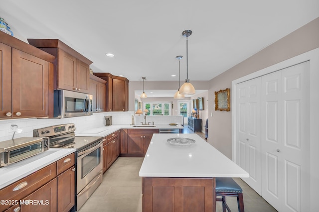83 Parkway Dr Unit E, Freehold, NJ 07728 - kitchen with backsplash, appliances with stainless steel finishes, a sink, and light countertops