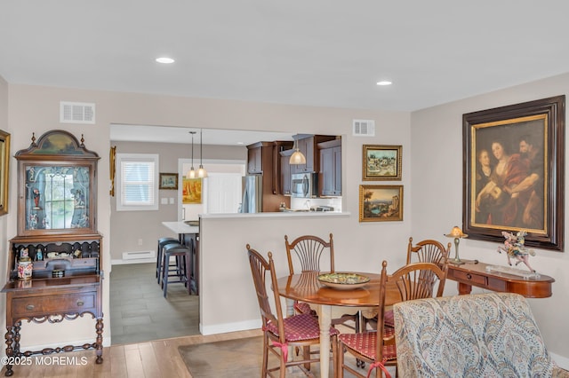 83 Parkway Dr Unit E, Freehold, NJ 07728 - dining room with visible vents, recessed lighting, wood finished floors, and baseboard heating
