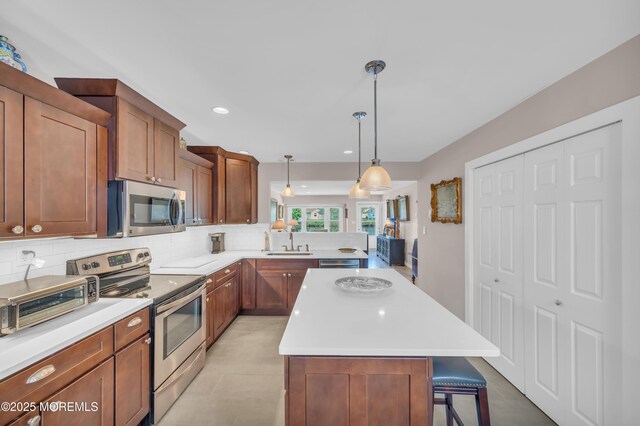 83 Parkway Dr Unit E, Freehold, NJ 07728 - kitchen with backsplash, appliances with stainless steel finishes, a sink, and light countertops
