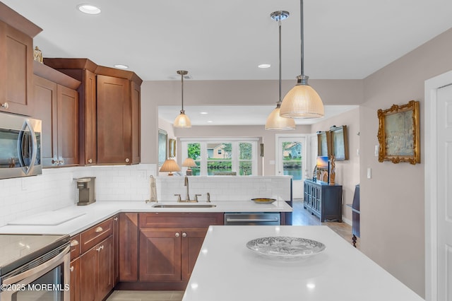 83 Parkway Dr Unit E, Freehold, NJ 07728 - kitchen with decorative backsplash, a sink, light countertops, stainless steel appliances, and recessed lighting