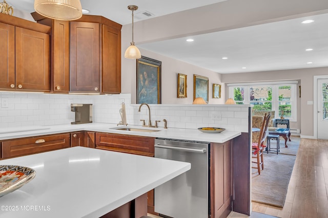 83 Parkway Dr Unit E, Freehold, NJ 07728 - kitchen featuring a kitchen breakfast bar, dishwasher, a sink, light countertops, and a peninsula