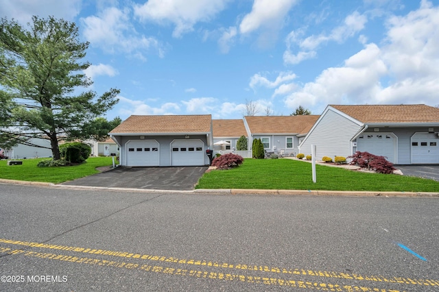83 Parkway Dr Unit E, Freehold, NJ 07728 - ranch-style house with an attached garage, driveway, and a front lawn