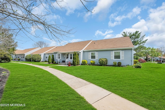 83 Parkway Dr Unit E, Freehold, NJ 07728 - ranch-style house featuring roof with shingles and a front yard