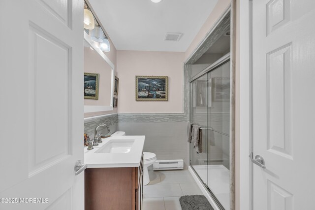 83 Parkway Dr Unit E, Freehold, NJ 07728 - full bathroom featuring vanity, tile patterned floors, tile walls, a baseboard heating unit, and a stall shower