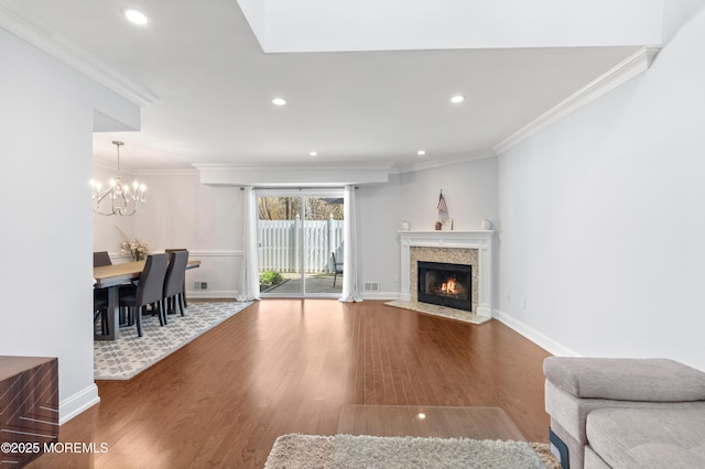 21 Spring Ct, Tinton Falls, NJ 07724 - living room with a high end fireplace, ornamental molding, wood finished floors, and a chandelier
