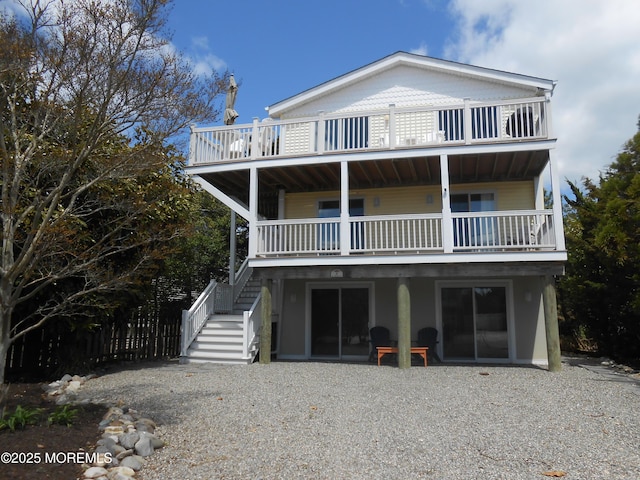 exterior space with stairs and a balcony