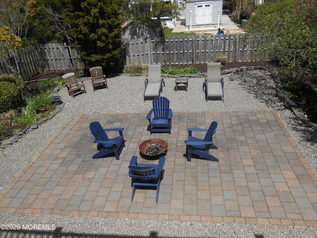 view of patio / terrace featuring a fire pit and fence
