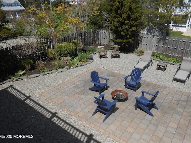 view of patio featuring an outdoor fire pit and fence
