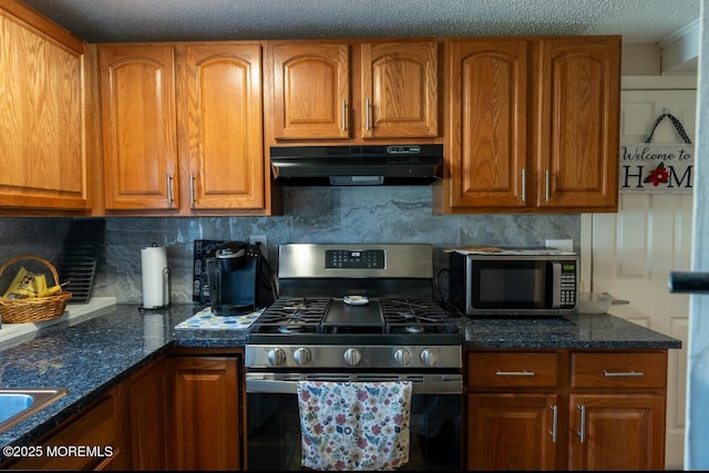 3124 Stanley Dr, Toms River, NJ 08753 - kitchen featuring appliances with stainless steel finishes, under cabinet range hood, brown cabinets, dark stone counters, and backsplash