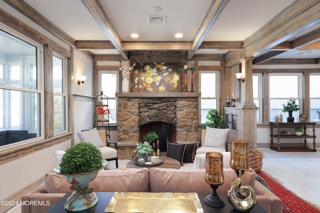 interior space featuring beamed ceiling, a stone fireplace, visible vents, and coffered ceiling