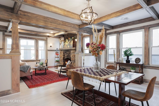 dining area featuring wood finished floors, beam ceiling, and coffered ceiling