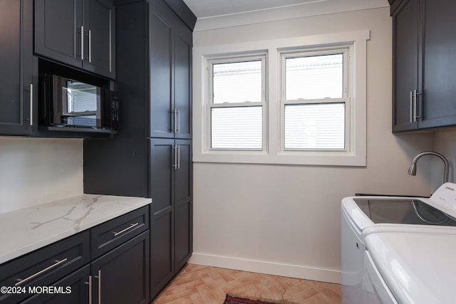 laundry area featuring cabinet space, washing machine and clothes dryer, and baseboards