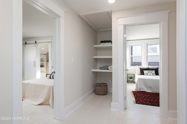 interior space with attic access, recessed lighting, and a barn door
