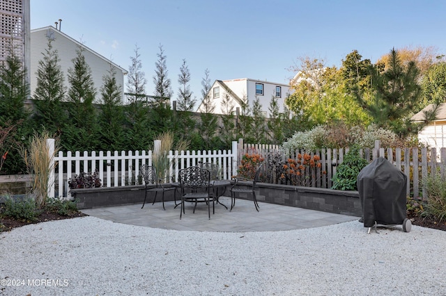 view of patio / terrace featuring fence and a grill