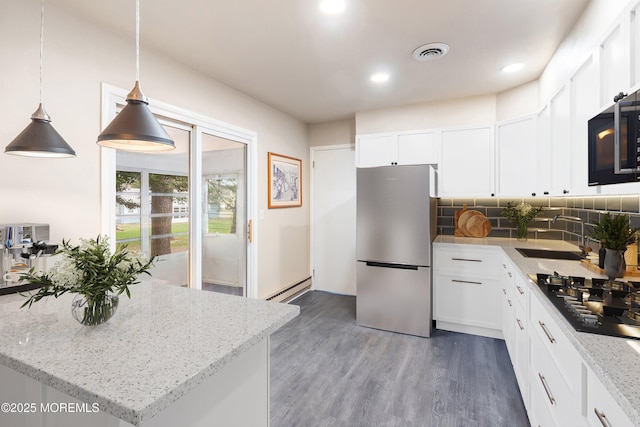 1 Adams Ct, Whiting, NJ 08759 - kitchen featuring a sink, black cooktop, freestanding refrigerator, visible vents, and baseboard heating
