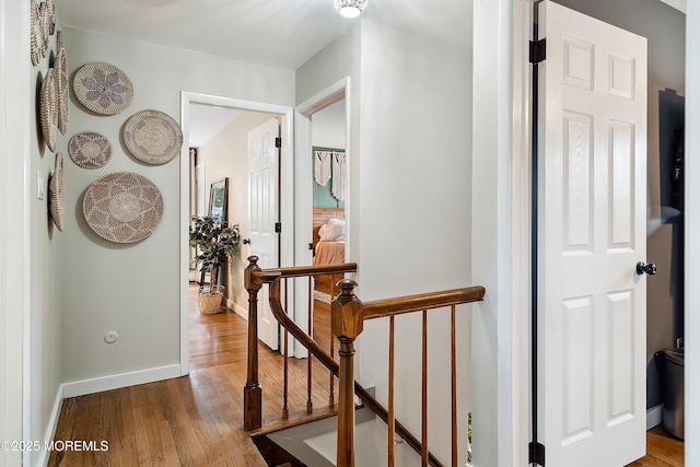 hallway with wood finished floors and baseboards