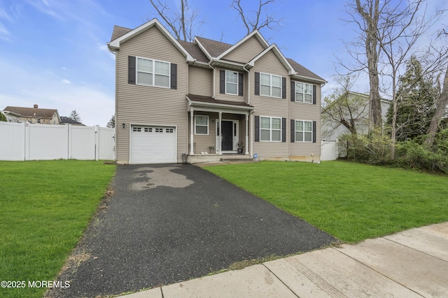 89 Orchard St, Freehold, NJ 07728 - view of front of home featuring an attached garage, aphalt driveway, fence, and a front lawn