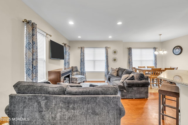 89 Orchard St, Freehold, NJ 07728 - living area featuring light wood-style flooring, recessed lighting, a chandelier, and a wealth of natural light