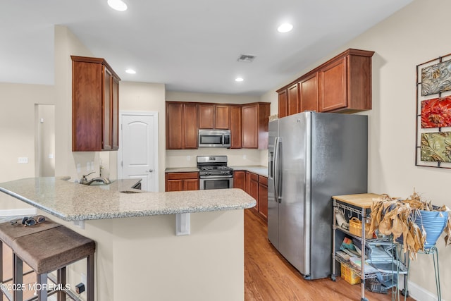 89 Orchard St, Freehold, NJ 07728 - kitchen with light wood-style floors, a peninsula, visible vents, recessed lighting, and stainless steel appliances
