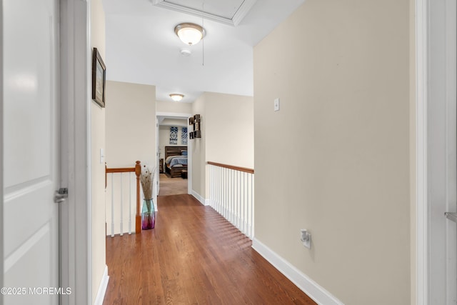 89 Orchard St, Freehold, NJ 07728 - corridor with wood finished floors, attic access, baseboards, and an upstairs landing