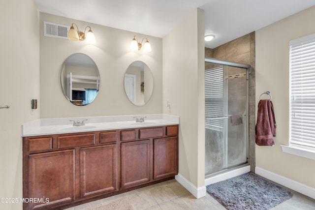 89 Orchard St, Freehold, NJ 07728 - bathroom featuring a shower stall, double vanity, visible vents, and a sink