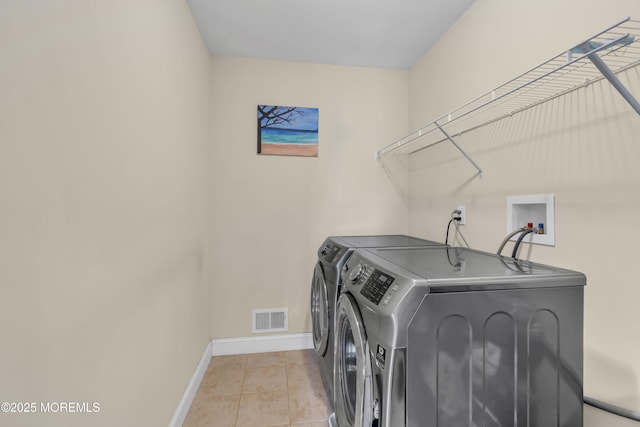 89 Orchard St, Freehold, NJ 07728 - clothes washing area featuring baseboards, light tile patterned floors, visible vents, laundry area, and washing machine and clothes dryer