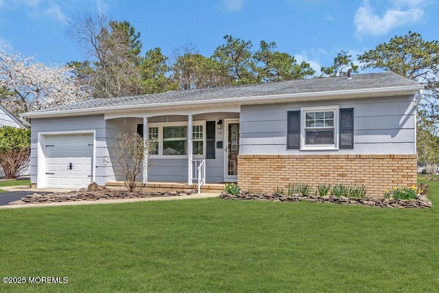 ranch-style house featuring an attached garage, brick siding, aphalt driveway, and a front yard