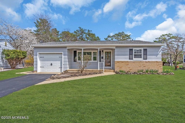 single story home featuring brick siding, aphalt driveway, a front yard, and a garage