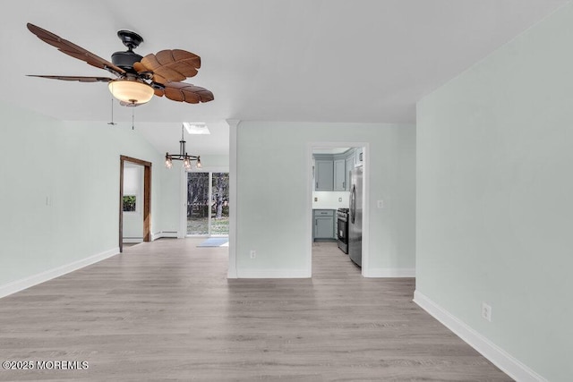 unfurnished living room featuring ceiling fan with notable chandelier, light wood finished floors, baseboards, lofted ceiling, and visible vents