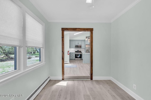 spare room featuring a baseboard radiator, crown molding, a baseboard heating unit, light wood-style floors, and baseboards