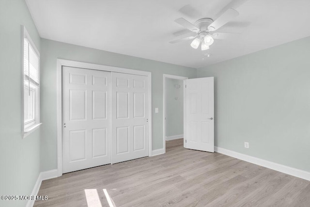 unfurnished bedroom featuring light wood-style flooring, baseboards, a closet, and ceiling fan