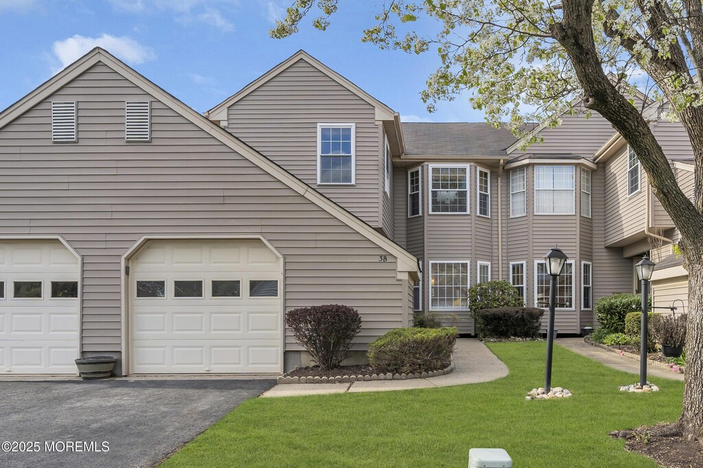 3 Wexford Dr Unit 3B, Monroe, NJ 08831 - view of property with asphalt driveway, a front lawn, and a garage