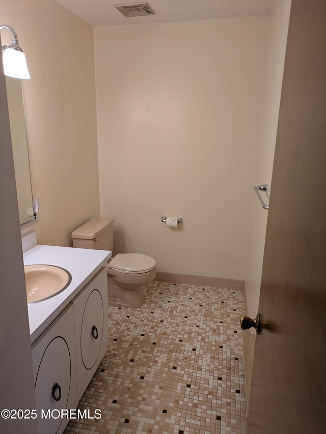 bathroom with visible vents, tile patterned flooring, vanity, toilet, and baseboards