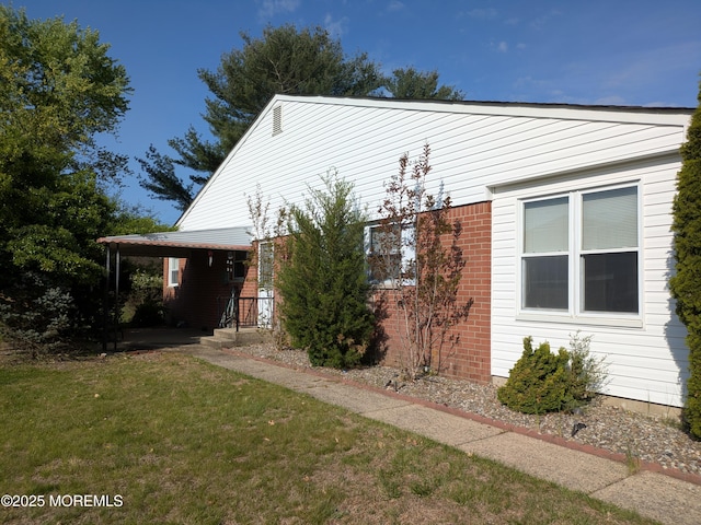 view of front of house with brick siding and a front lawn