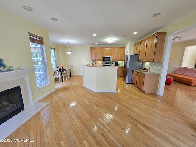 3 Great Beds Way S, Amboy, NJ 08879 - kitchen featuring appliances with stainless steel finishes, light wood finished floors, a fireplace, recessed lighting, and baseboards