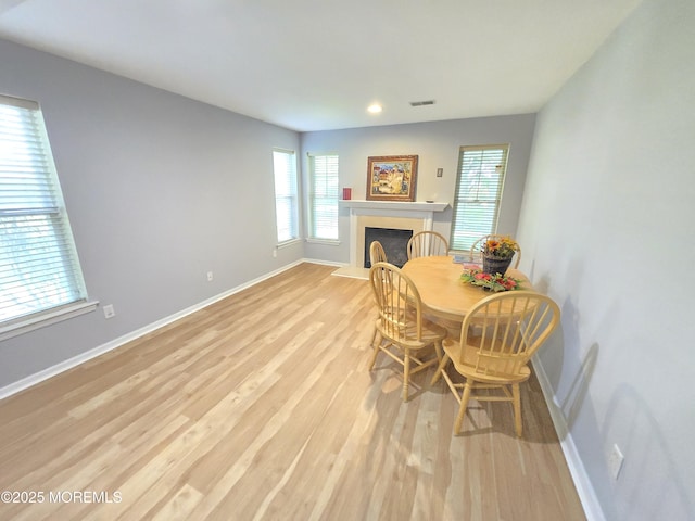 3 Great Beds Way S, Amboy, NJ 08879 - dining area featuring light wood-type flooring, healthy amount of natural light, a fireplace with raised hearth, baseboards, and recessed lighting