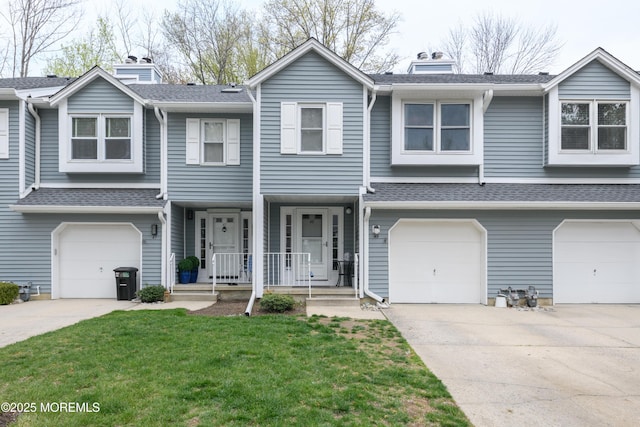 multi unit property featuring roof with shingles, a front lawn, driveway, a porch, and a garage