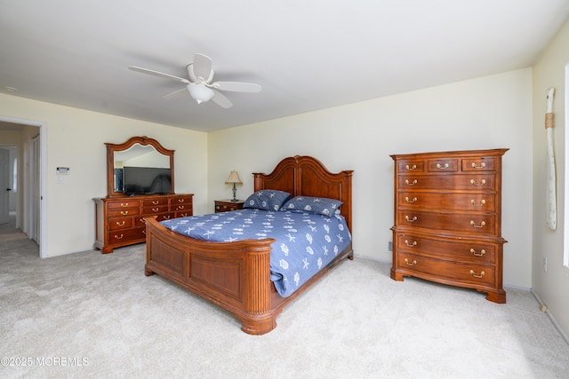 bedroom with a ceiling fan and light colored carpet