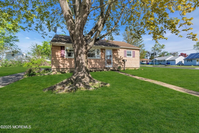 ranch-style home with a front lawn