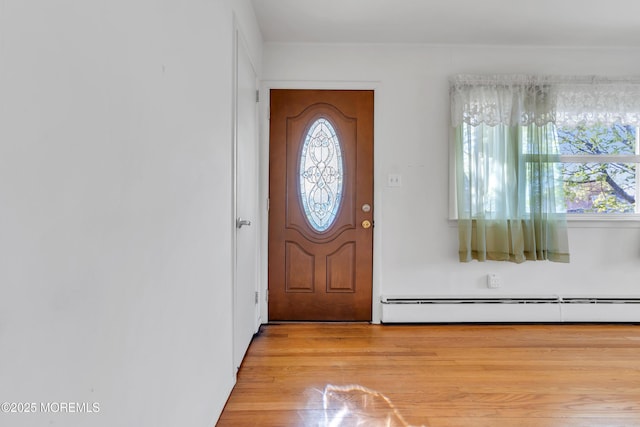 entryway with light wood-style floors and baseboard heating