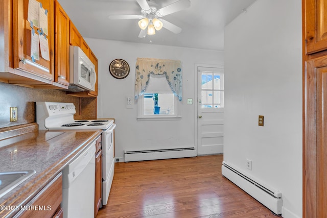 kitchen featuring baseboard heating, light wood-style flooring, white appliances, and brown cabinetry
