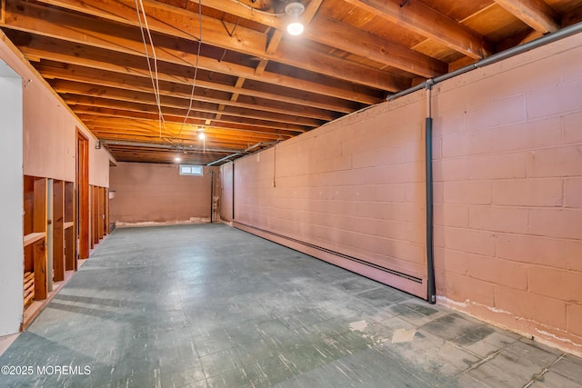 basement with tile patterned floors and a baseboard radiator