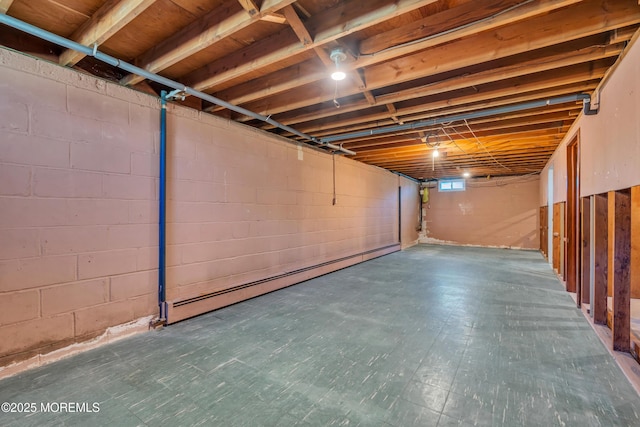 below grade area with a baseboard heating unit