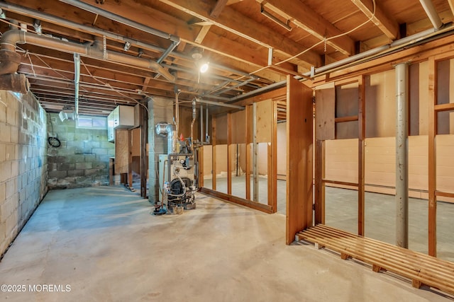 unfinished below grade area featuring a heating unit and concrete block wall