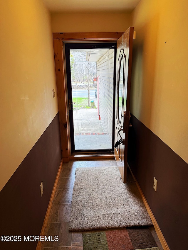 doorway to outside with baseboards