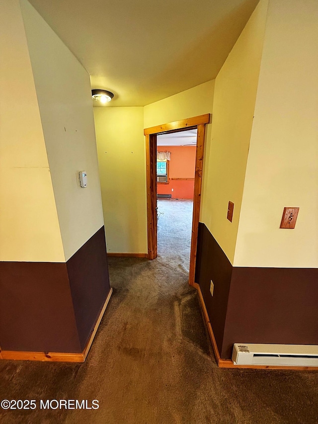 hallway featuring baseboards, carpet, and baseboard heating