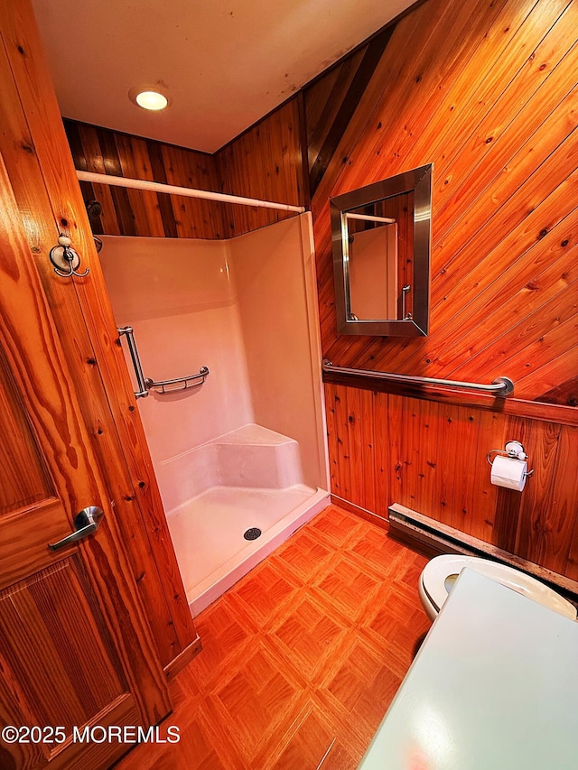 full bathroom featuring recessed lighting, wood walls, and a shower stall