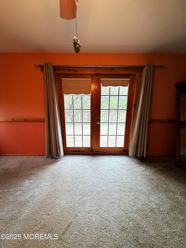 carpeted spare room with french doors