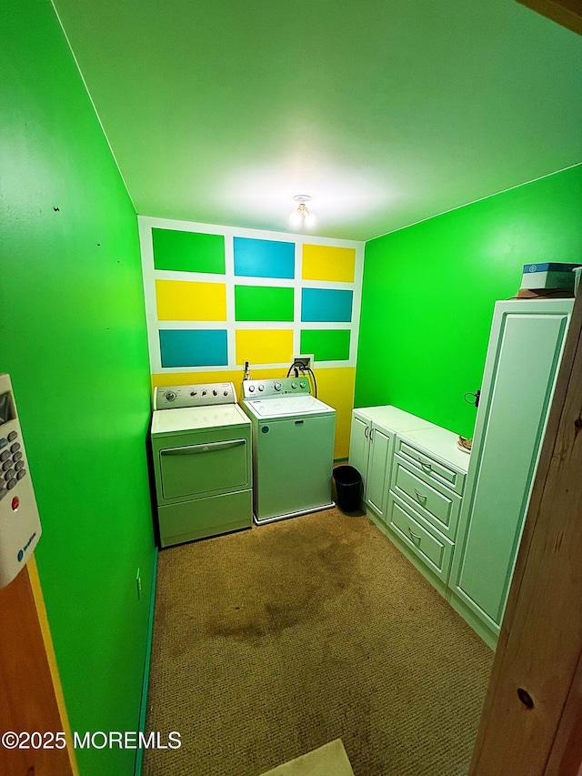 laundry area with laundry area, washer and clothes dryer, and dark colored carpet